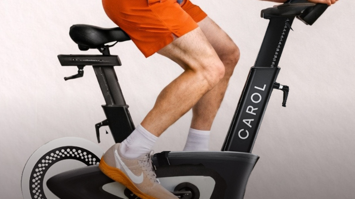A rider pedaling a CAROL Bike, shown from the waist down